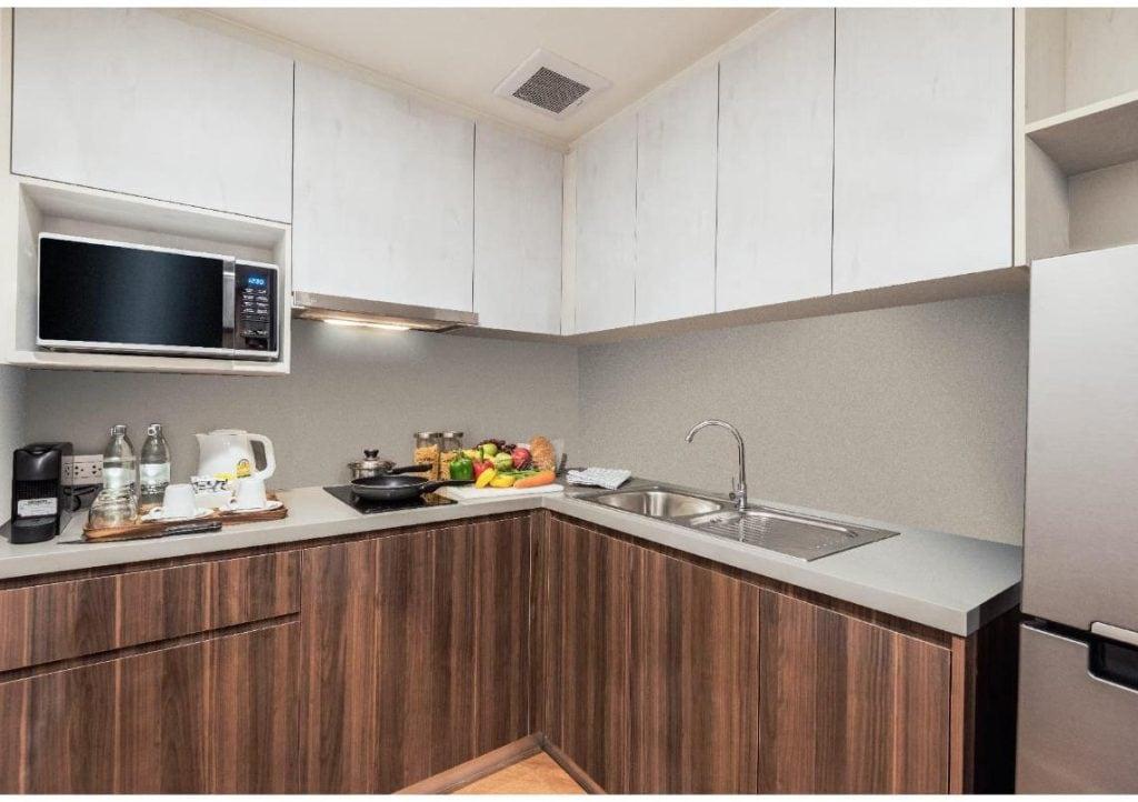 A kitchen at Amanta Hotel & Residence Sathorn