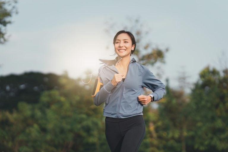 A woman jogging, enjoying the benefits of running in the morning
