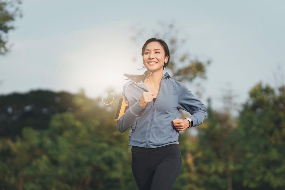 A woman jogging, enjoying the benefits of running in the morning