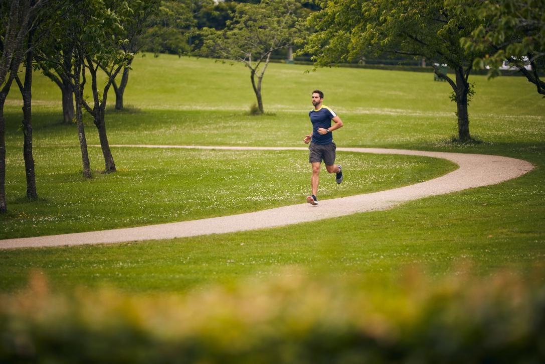 A runner exercises in an urban public park
