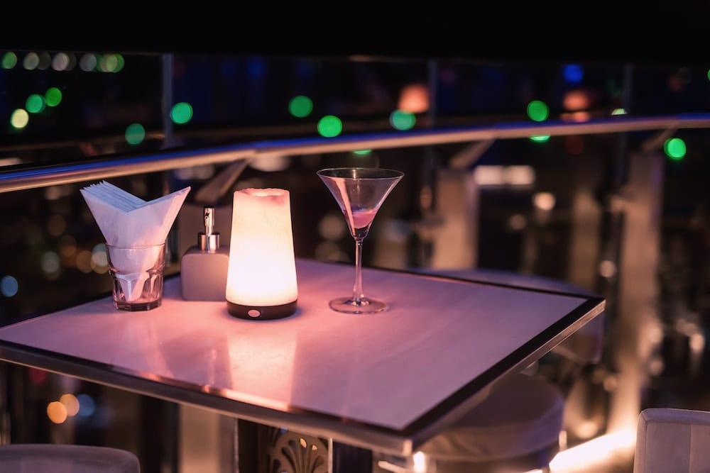 A cocktail on a table at a rooftop bar. There’s much to enjoy in the nightlife in Sathorn