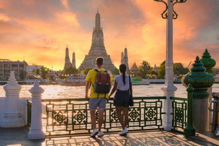 Couple watching the sunset at Wat Arun, one of the top activities for couples in Bangkok