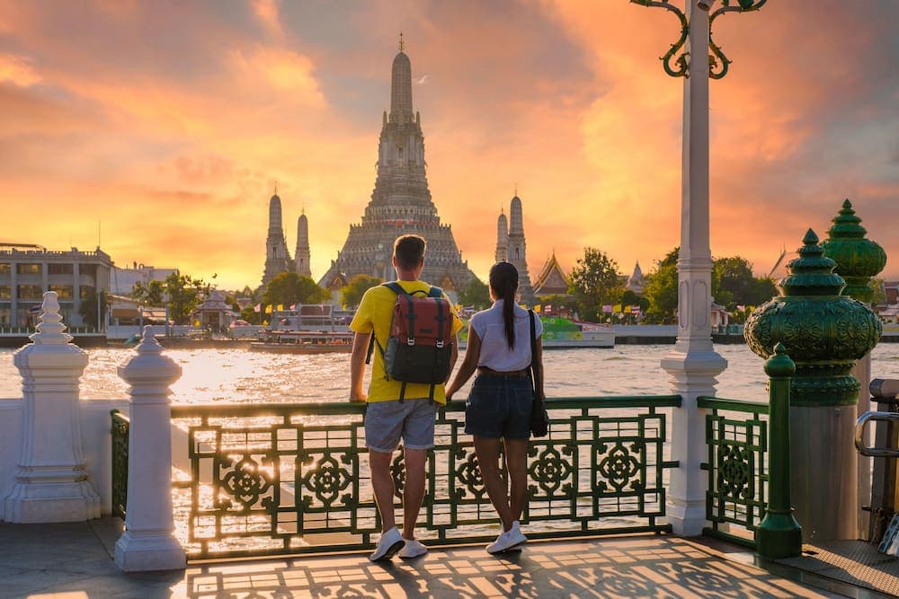 Couple watching the sunset at Wat Arun, one of the top activities for couples in Bangkok