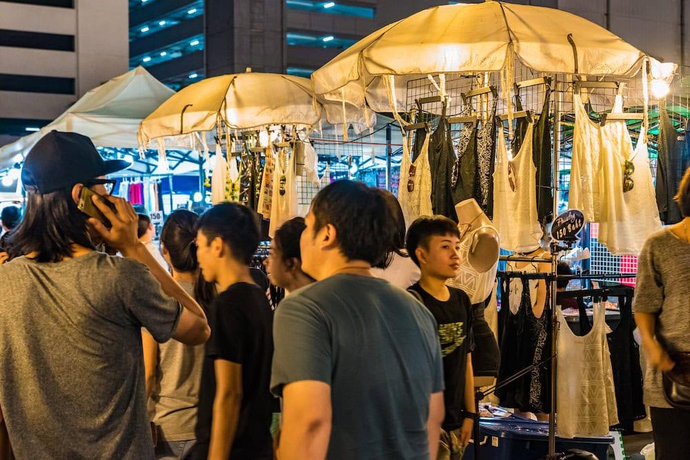Visitors browsing clothing stalls at the Rot Fai night market Ratchada in Bangkok
