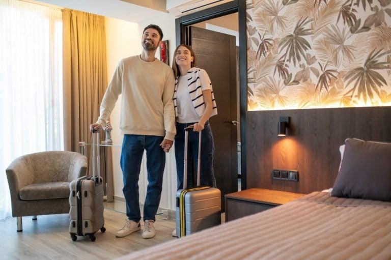 A couple checks out their hotel room
