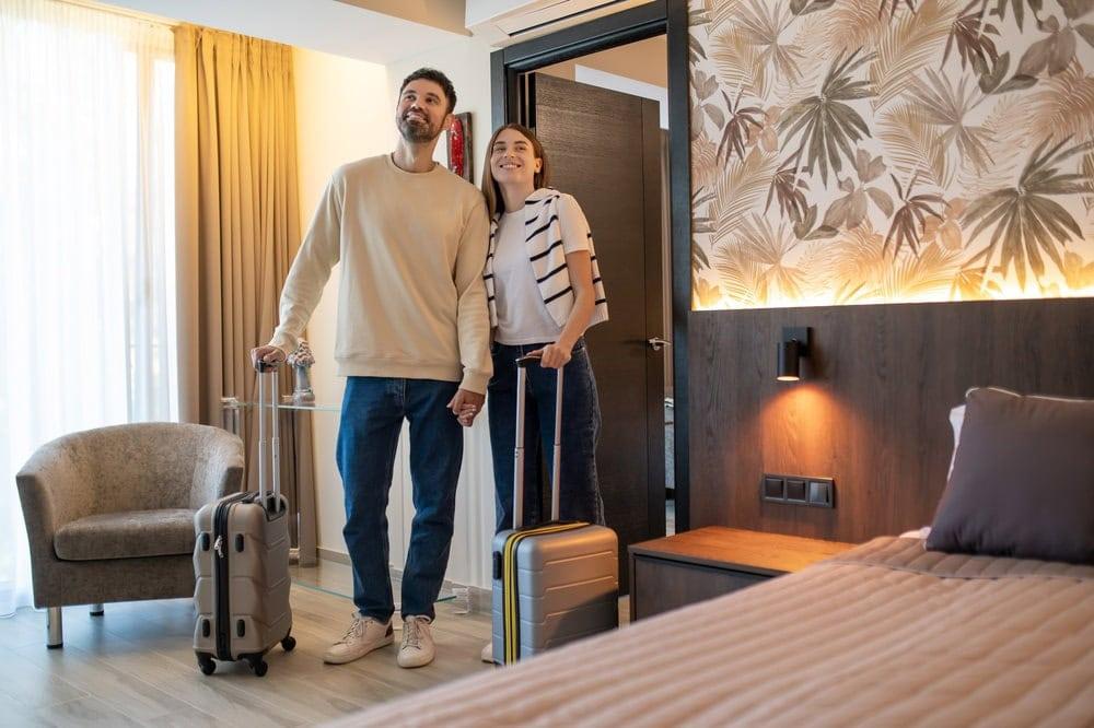 A couple checks out their hotel room