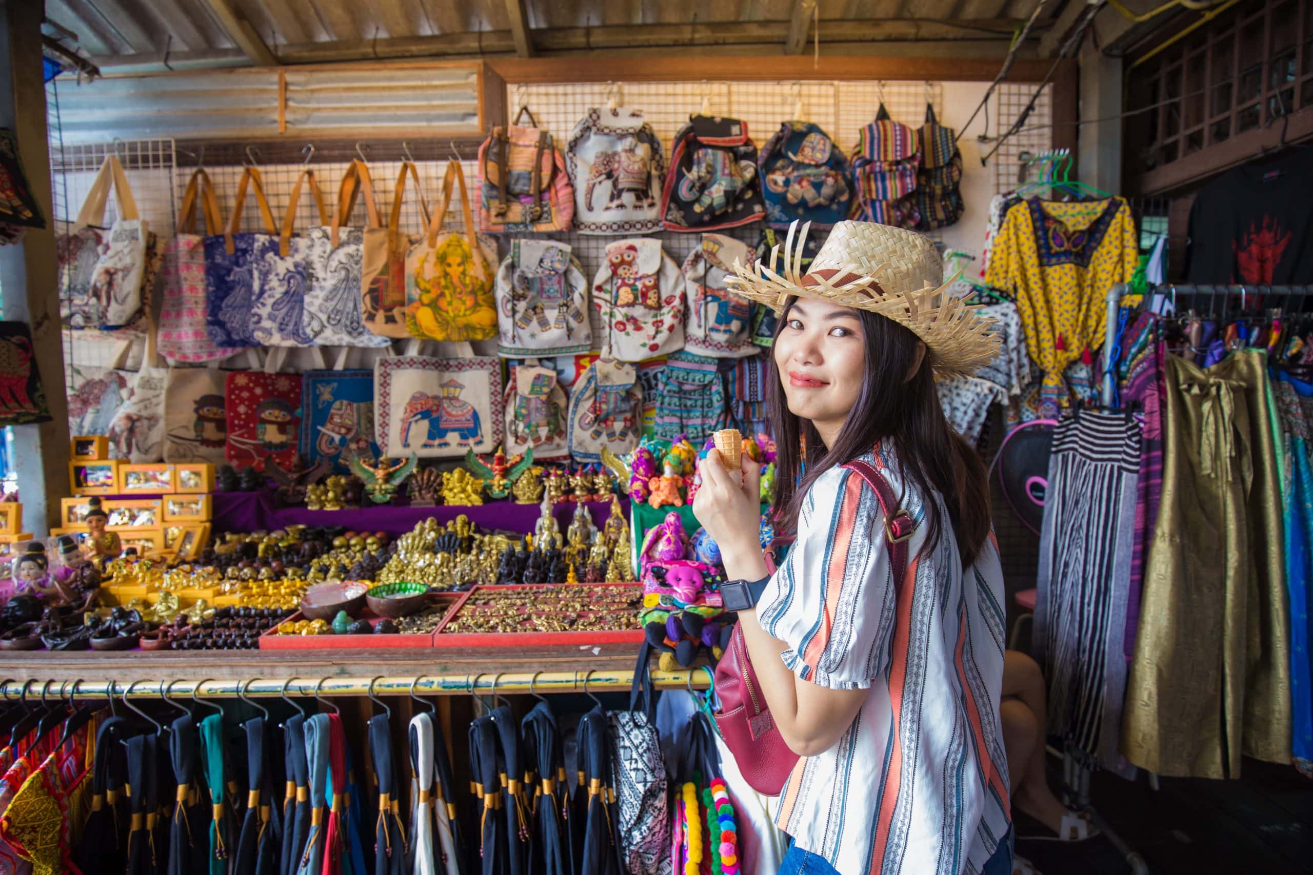 A woman solo travelling in Bangkok visits a night market stall.