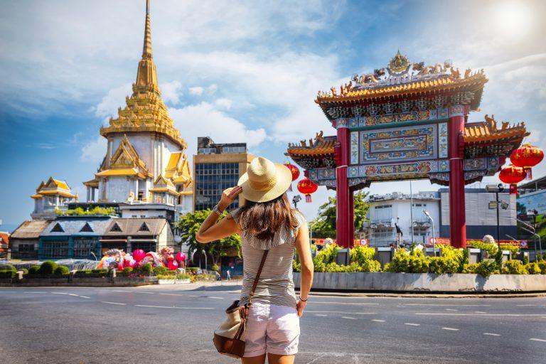 A young woman sightseeing in Bangkok as part of a solo travel trip.