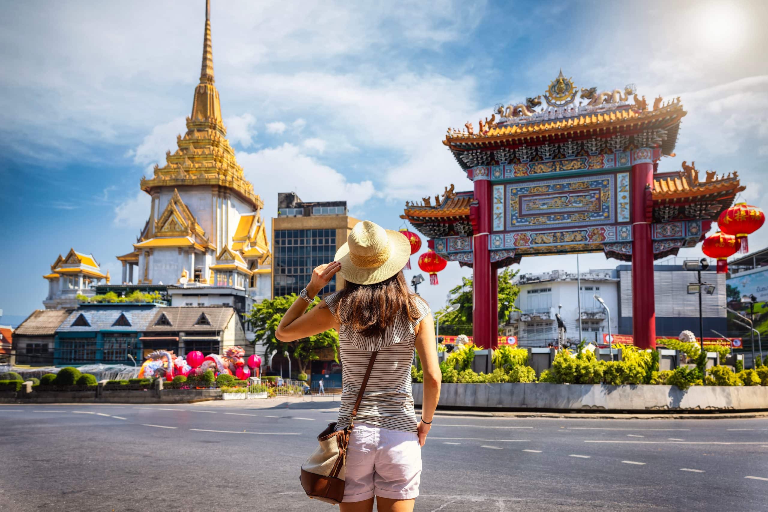 A young woman sightseeing in Bangkok as part of a solo travel trip.
