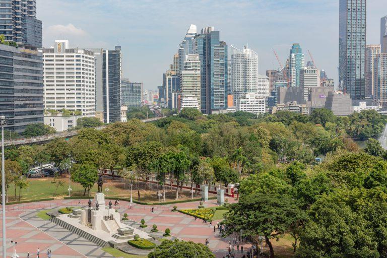 Aerial view of Lumpini, the best park to run in Bangkok, beside the city skyline