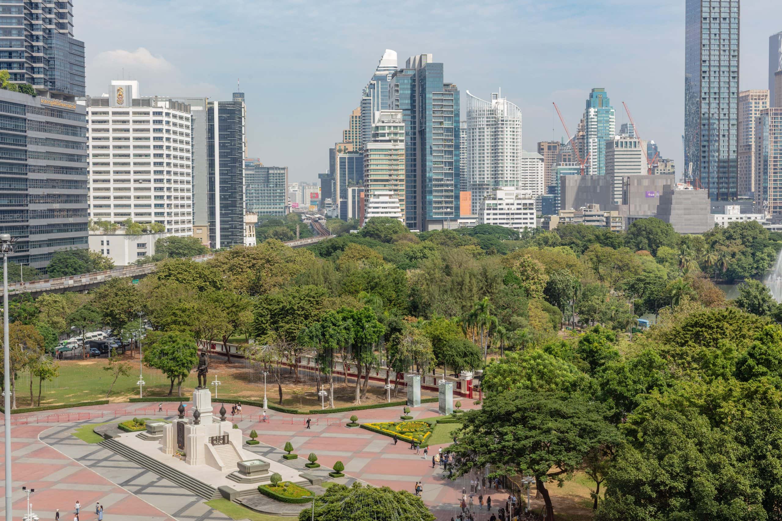 Aerial view of Lumpini, the best park to run in Bangkok, beside the city skyline