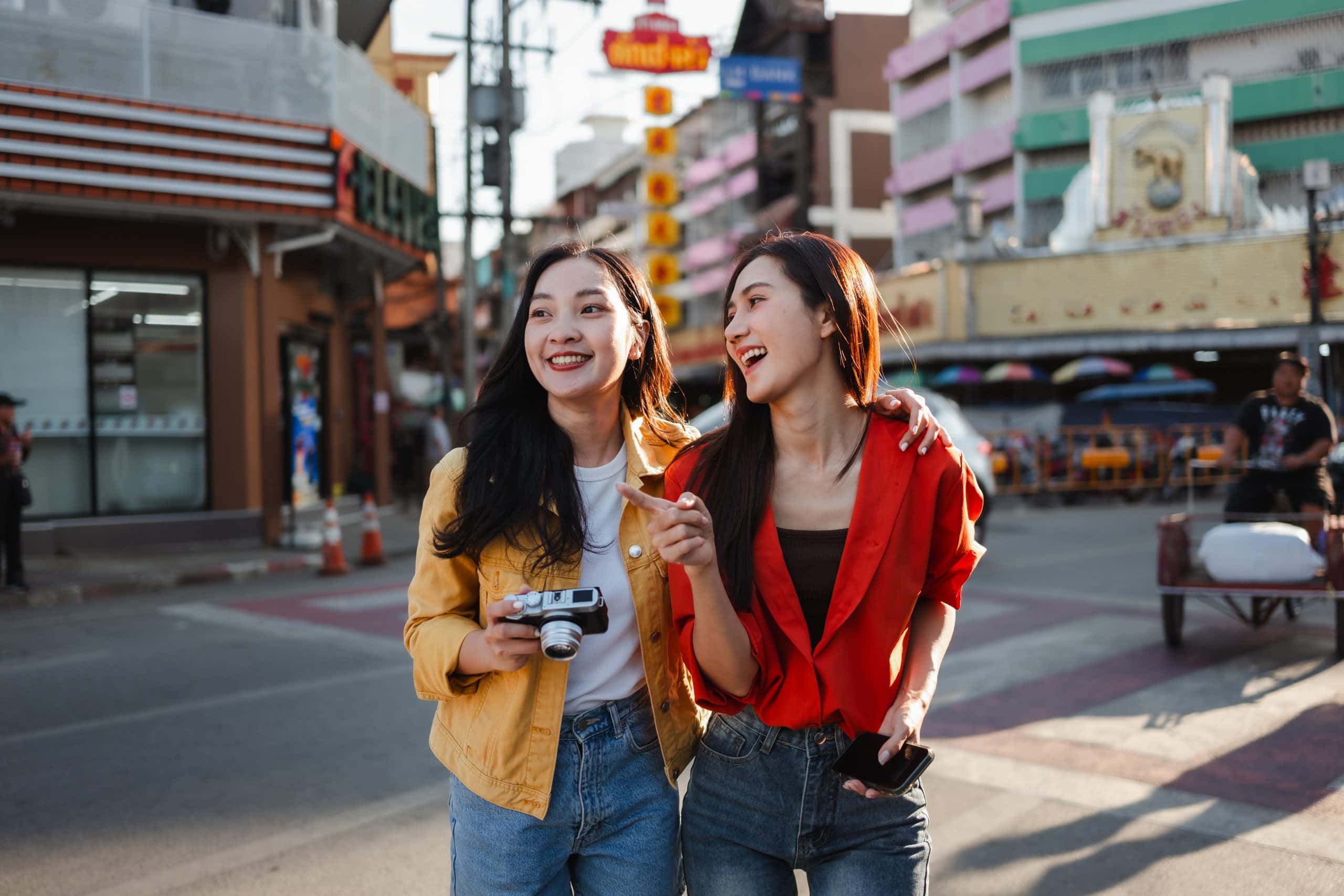 Two girls exploring one of Bangkok’s many happening streets during their Thailand girls’ trip.
