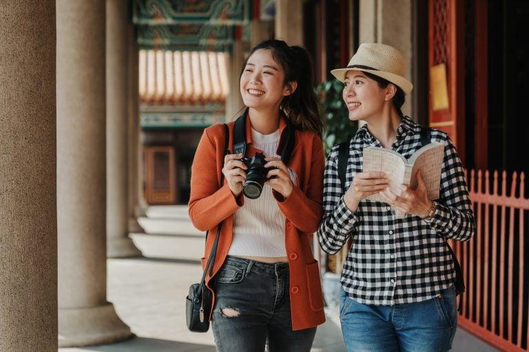 Two girls visiting one of the temples in Bangkok during their trip to Thailand.