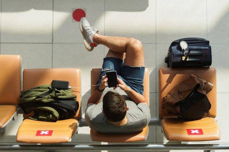 A traveler in arrivals waiting for his ride from Suvarnabhumi Airport to Sathorn.